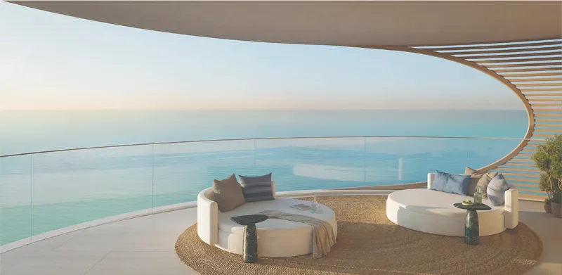 Render of a curved private terrace at Fahid Beach Terraces with two round daybeds and a glass balustrade facing the sea