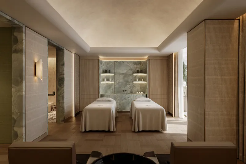 Render of a spa treatment room with two massage beds and a marble wall at Four Seasons Private Residences Dubai at DIFC