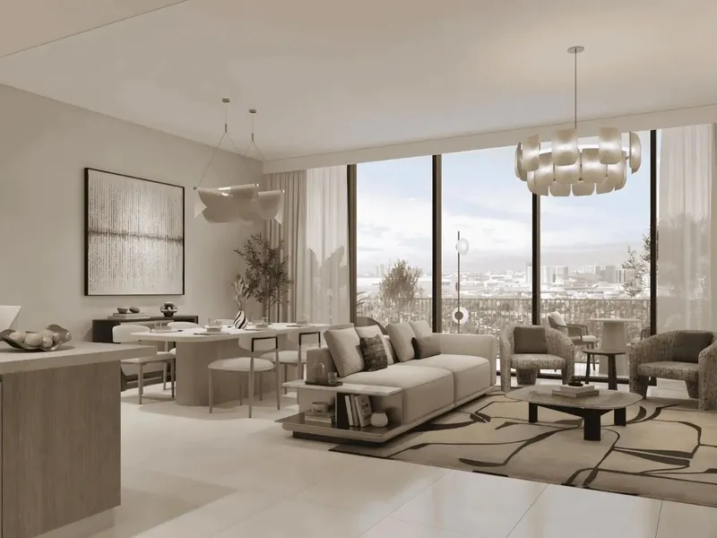 Living and dining room of an apartment at Ghadeer looking out over low rise rooftops and open ground