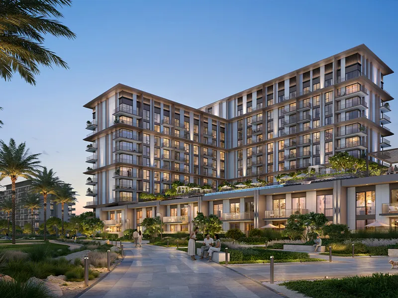 Render of a Golf Trails mid-rise residence at Emaar South at dusk, with podium landscaping in front.