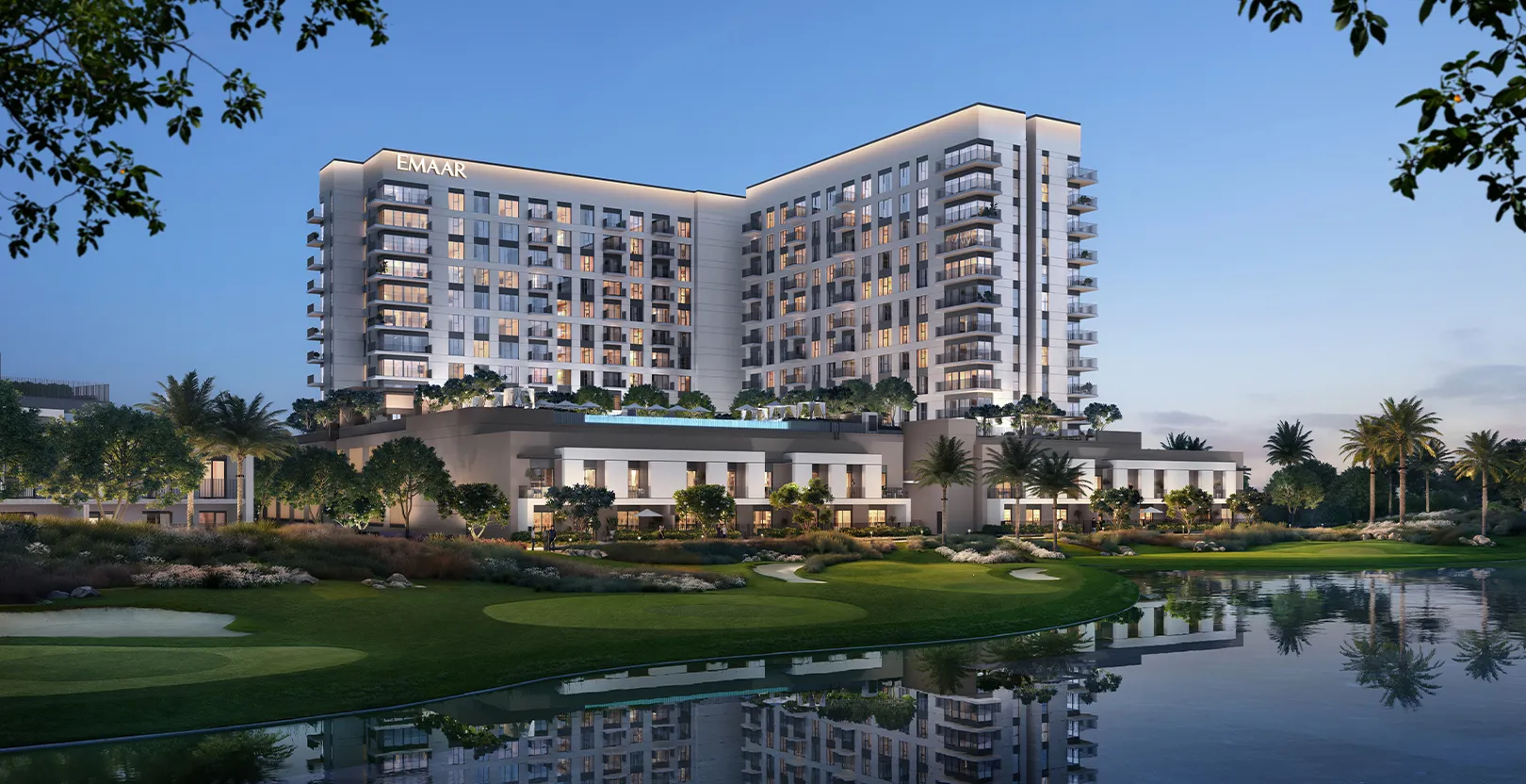 Render of the Golf Vale building at dusk reflected in a lake on the Emaar South golf course