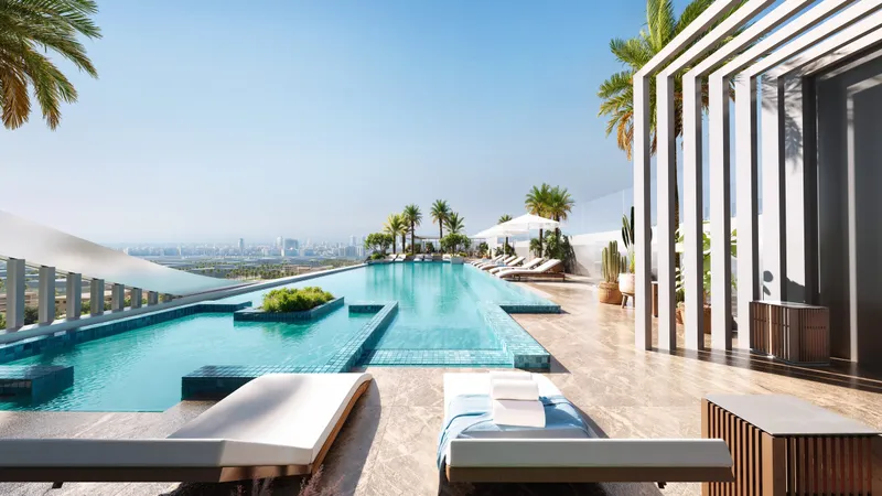 Rooftop infinity pool at LINEA by HOLM with sun loungers, planting and a shaded pergola