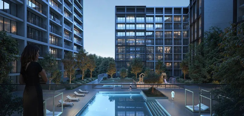 Evening render of the residents' swimming pool at Jenna, Aljada, with sun loungers and planting between the buildings