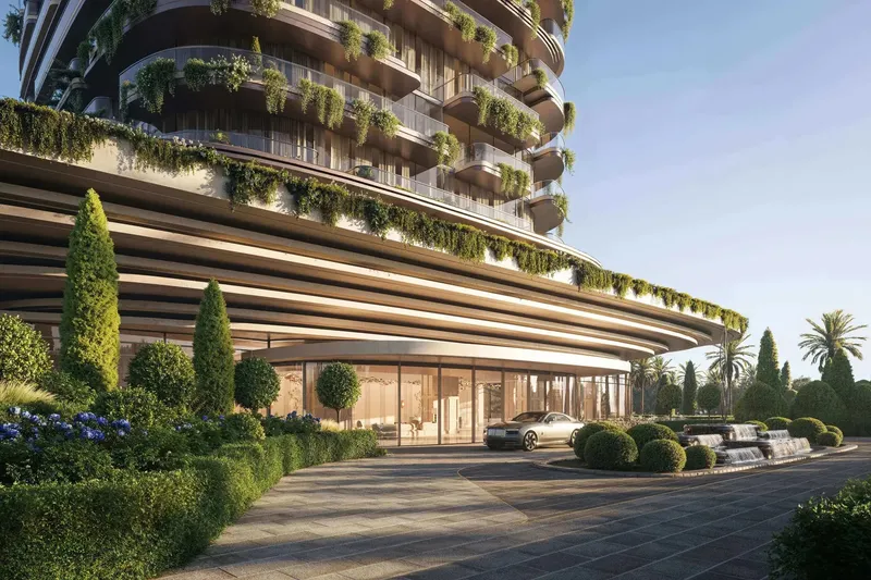 Arrival court beneath the curved podium of Le Château by BEYOND, with planted balconies above