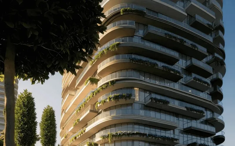 Curving white and bronze balconies with planters on the Le Château facade