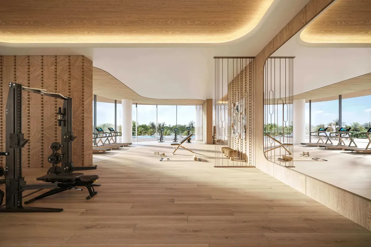Indoor gym with timber finishes and garden views at Le Château