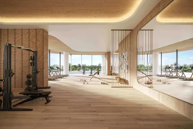Indoor gym with timber finishes and garden views at Le Château