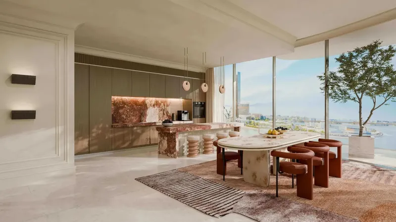 Kitchen and dining area with marble island and coastal views at Le Château