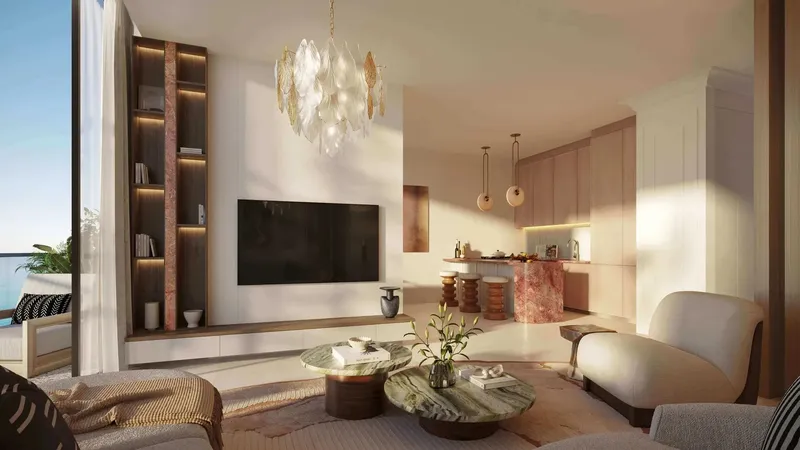 Lounge with a feature bookcase and open kitchen at Le Château