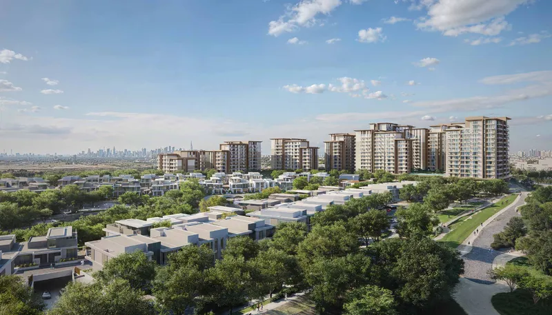 Aerial render across villas toward the Expo Valley Views apartment cluster with the Dubai skyline beyond