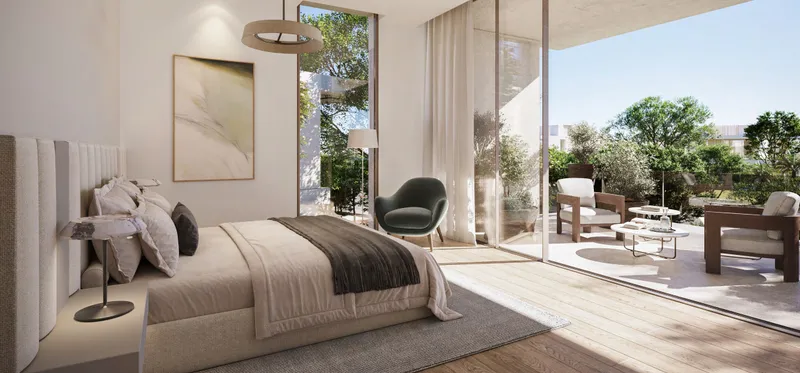 Bedroom with floor-to-ceiling glass opening to a garden terrace at The Acres Estates