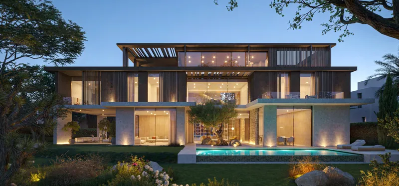 Ivory Collection 7 bedroom villa at The Acres Estates at dusk with a pool and a mature tree