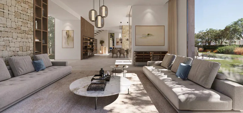Living room in an Ivory Collection villa with stone walls, sofas and garden views