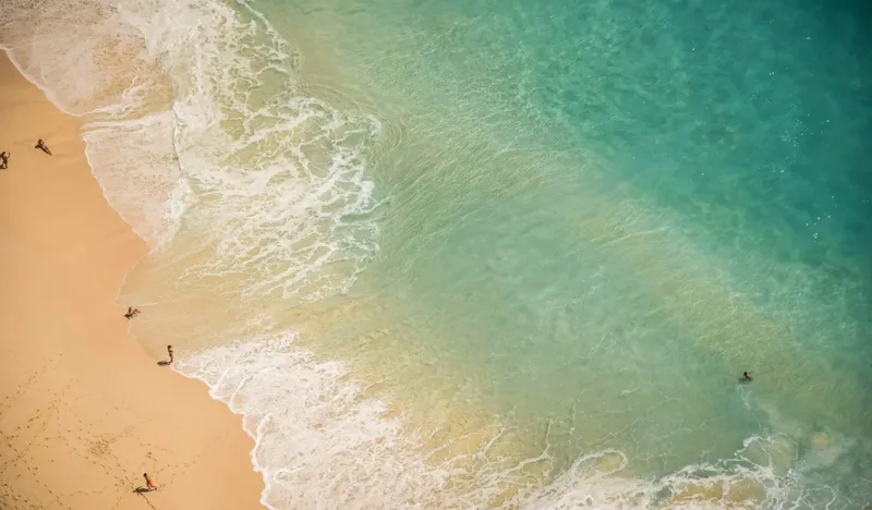 Aerial view of the sand and clear water on the Al Marjan Island beach