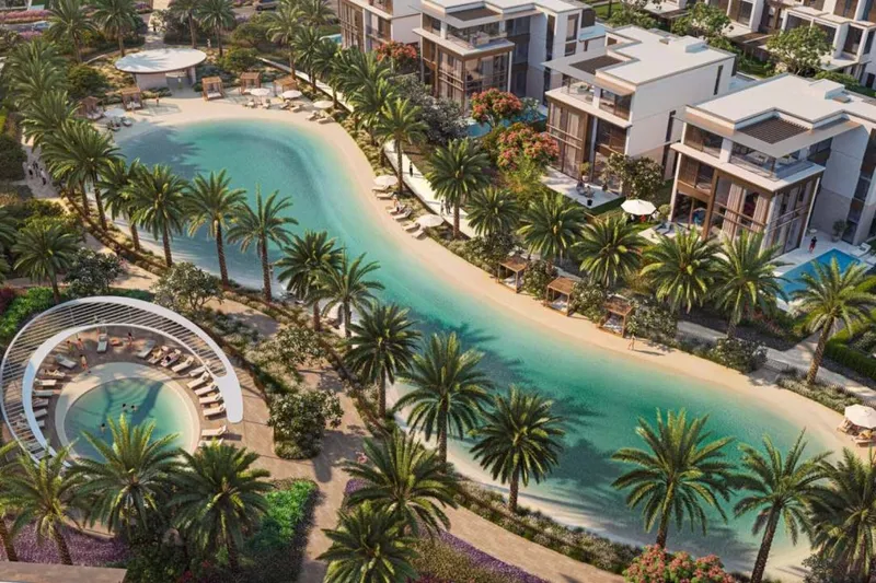 Render of the swimmable lagoon at Nad Al Sheba Gardens with a sand edge, palm planting and a circular shaded sun deck