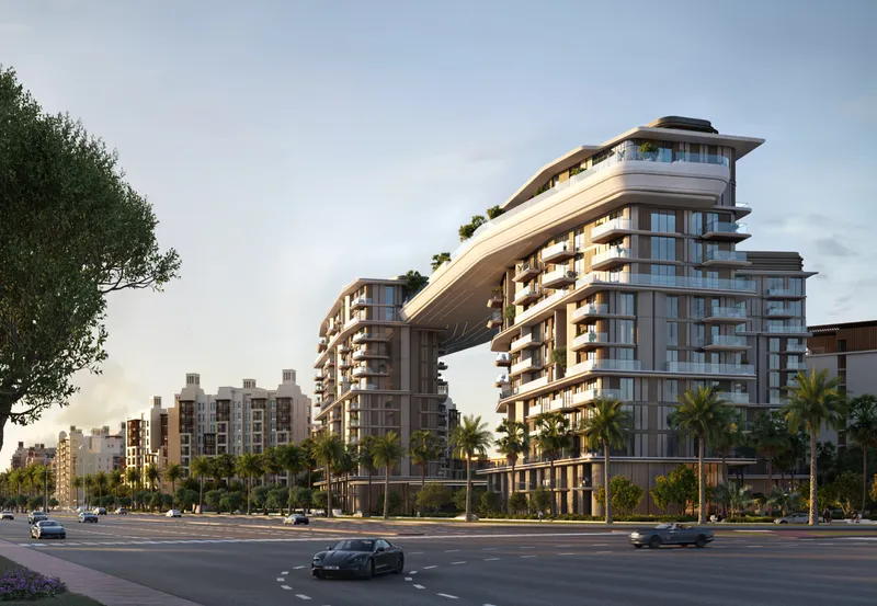 Render of Nourelle by Meraas from the street, with the skybridge spanning between the buildings and palm trees along the road