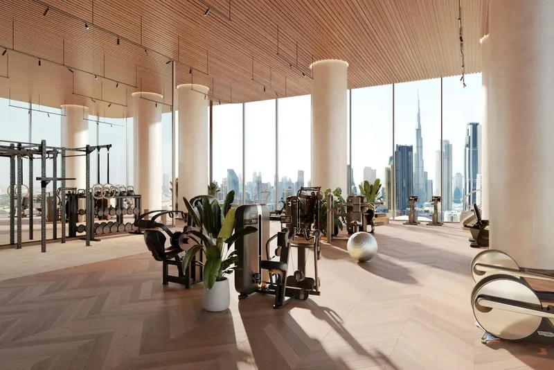 Render of the VELA Viento fitness centre with timber ceiling, round columns and floor-to-ceiling windows over Downtown Dubai