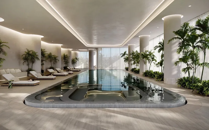 Render of the indoor lap pool at VELA Viento with loungers and planting under a curved lit ceiling