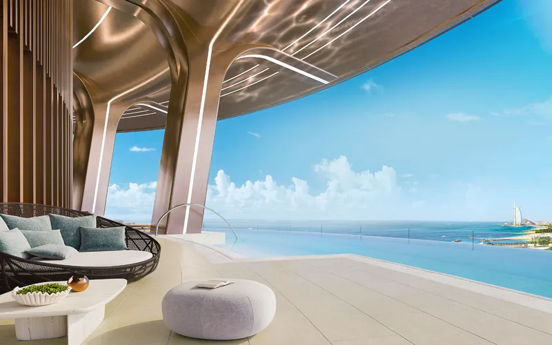Sky lounge seating beside a rooftop pool edge overlooking the Arabian Gulf