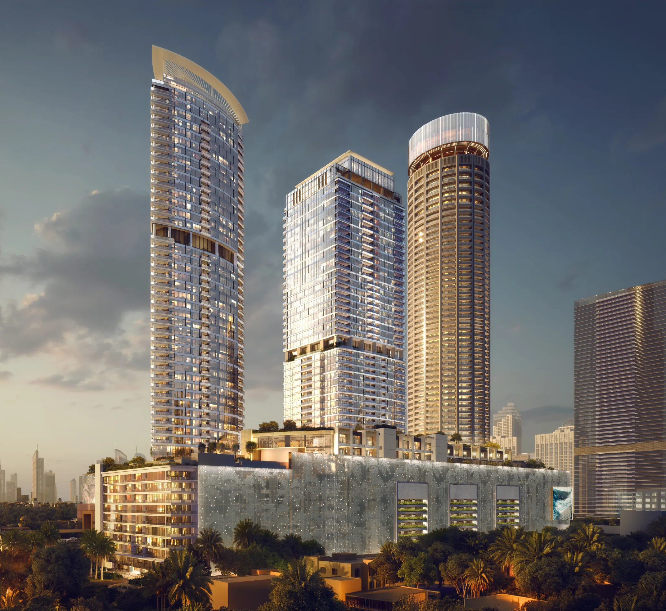 The three Palm Beach Towers by Nakheel above their podium at the entrance to Palm Jumeirah at dusk