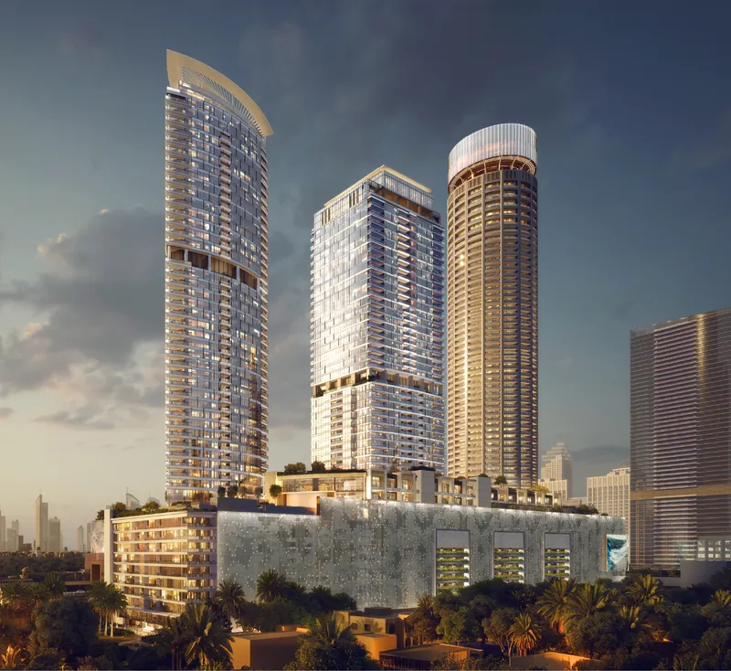 The three Palm Beach Towers by Nakheel above their podium at the entrance to Palm Jumeirah at dusk