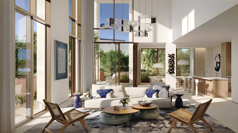 Double-height living room in a Palm Central duplex home with tall glazing