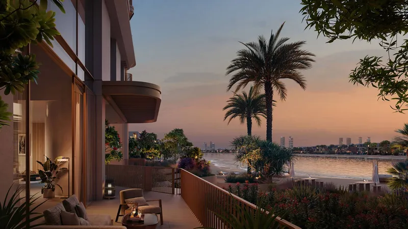 Garden terrace of a Palm Central home at dusk with palms and a view over the water
