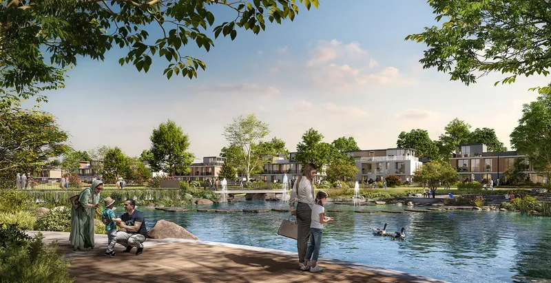 Render of a lake with fountains and a paved edge in front of Rivera townhouses