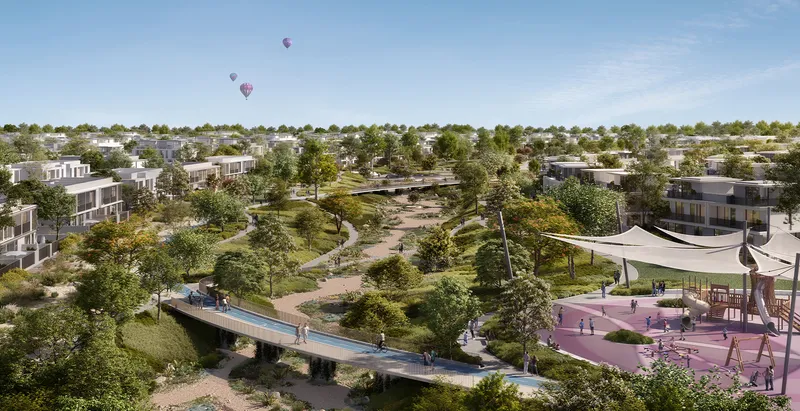 Aerial render of a green park with a footbridge, trails and a shaded play area among Rivera homes