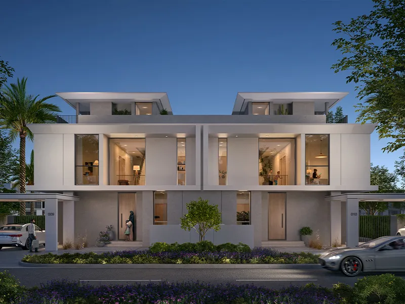 Render of Rivera townhouses at dusk with lit living rooms and roof terraces