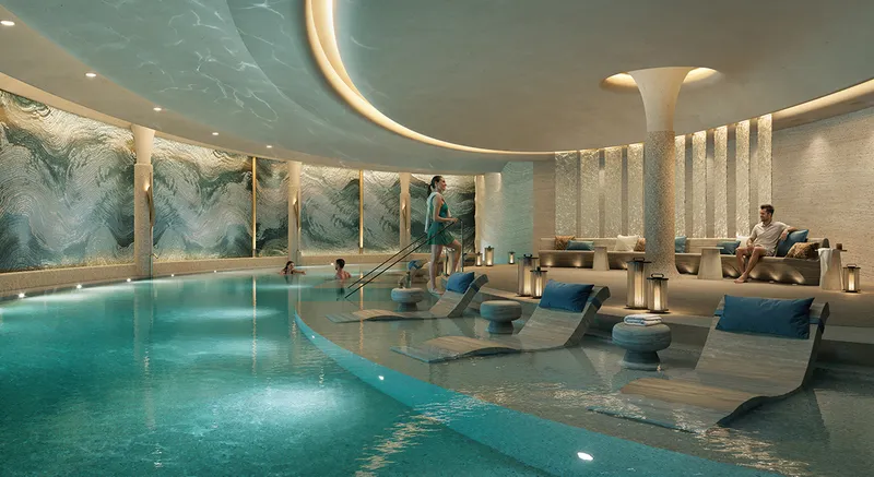Render of an indoor pool with loungers and a curved ceiling in the wellness facilities