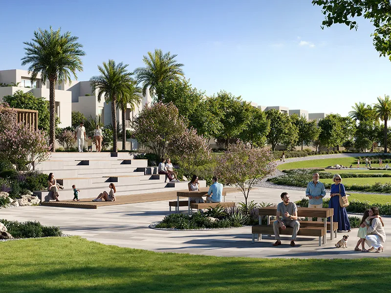 Render of residents in a landscaped park with timber seating steps and palm trees at Serro