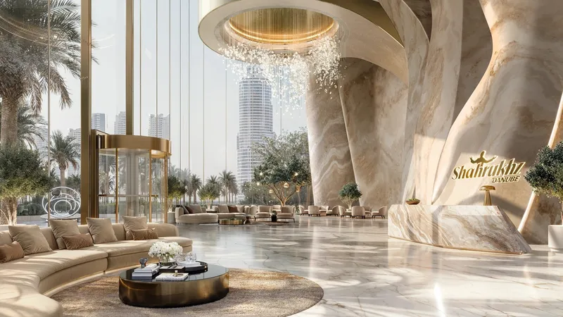 Double-height lobby at Shahrukhz with a sculpted stone column, chandelier and curved seating