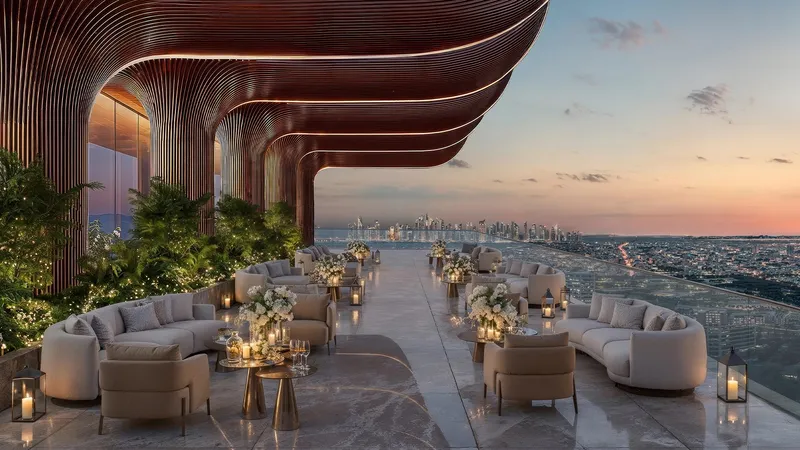 Open-air terrace lounge at Shahrukhz with fluted columns and seating, looking over Dubai at sunset