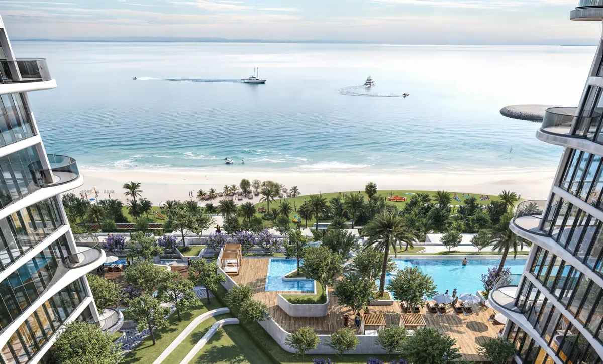 Pool deck and landscaped podium between the Sobha Aquamont towers, looking out to the beach and sea