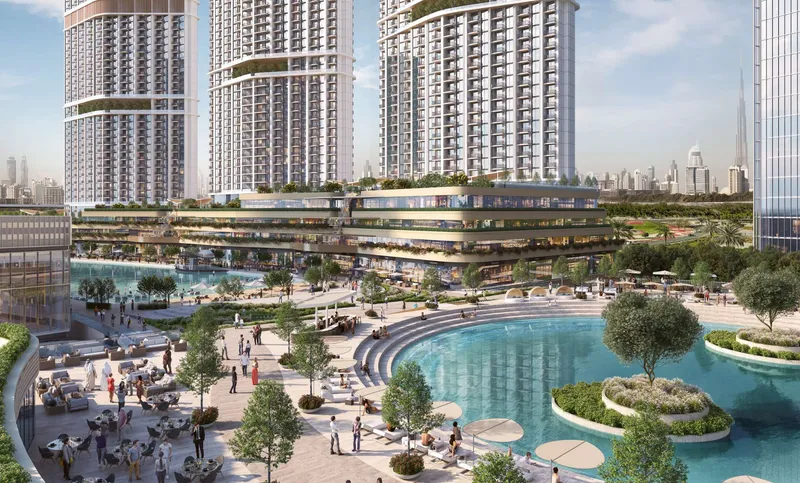 Render of the Skyscape towers above a landscaped lagoon plaza with cafes, with Burj Khalifa in the distance