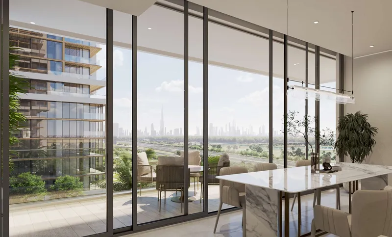 Sobha One dining area opening to a glazed balcony with a skyline view
