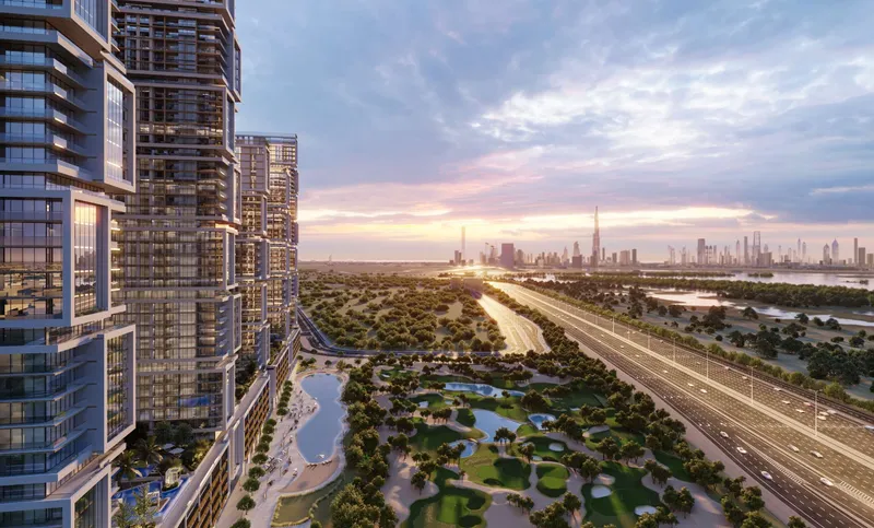 Sobha One towers at dusk above the golf course and Ras Al Khor Road