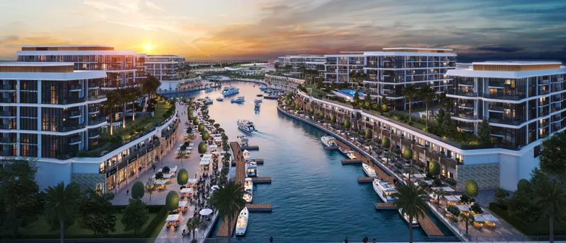 Render of the Marina Residences at Sobha Siniya Island lining a canal marina with moored boats at sunset