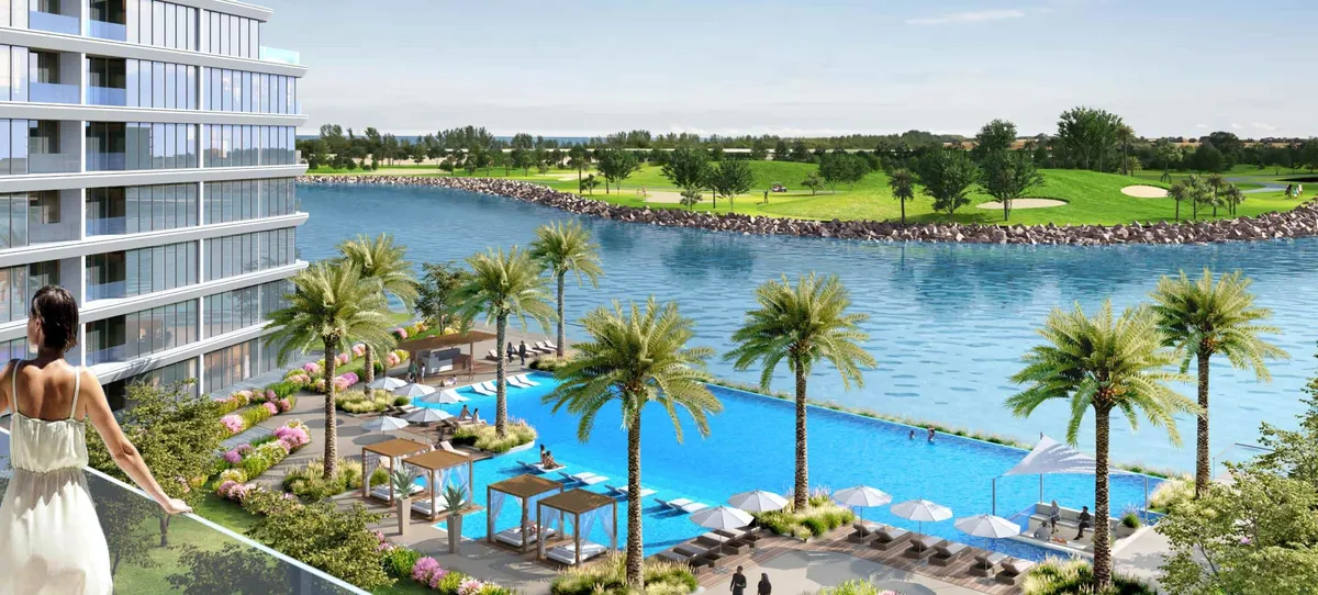 Render of a pool deck with palms overlooking the lagoon and golf course at Sobha Siniya Island