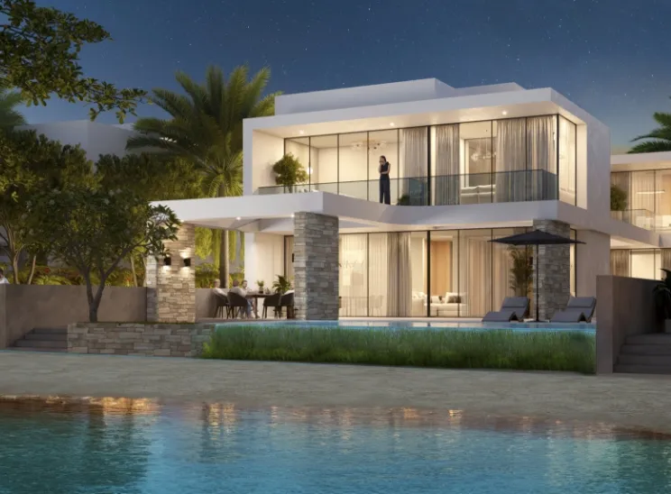 Render of a lit two-storey waterfront villa at Sobha Siniya Island at night