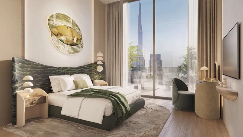Bedroom with a green upholstered headboard and a view of the Burj Khalifa