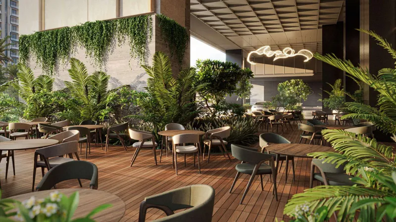 Shaded café terrace with timber decking, tables and hanging greenery at Sofitel Residences Dubai City View