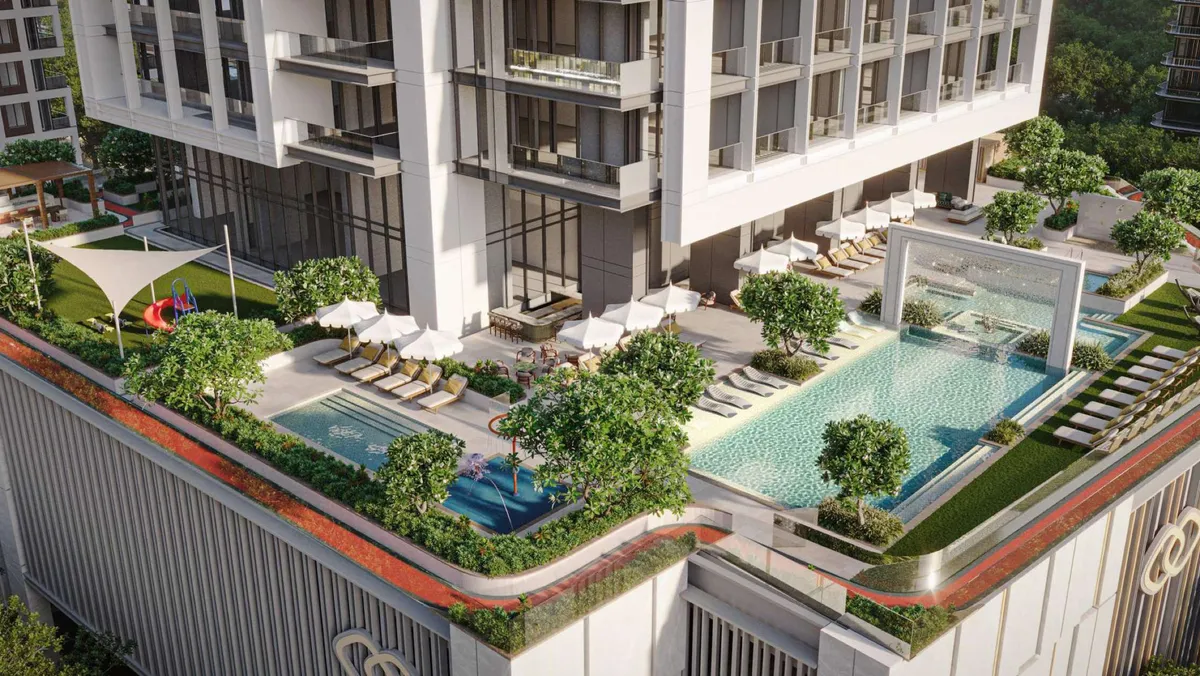 Aerial view of the podium deck at Sofitel Residences Dubai City View with pools, loungers and planting