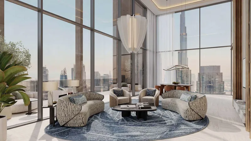 Double-height living room in a Sky Villa duplex with tall windows over Downtown Dubai