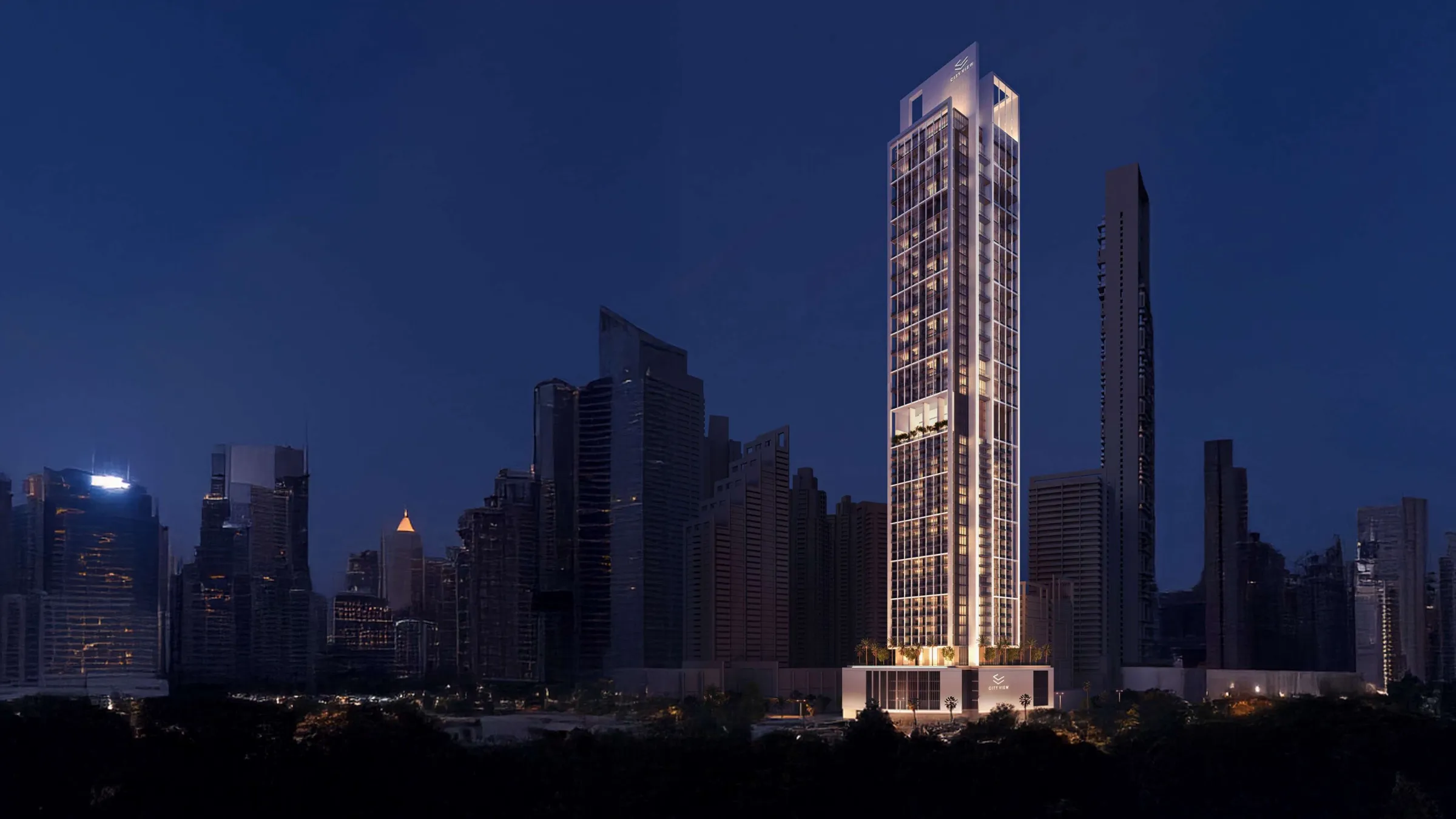 Sofitel Residences Dubai City View tower lit at night above the Downtown Dubai skyline