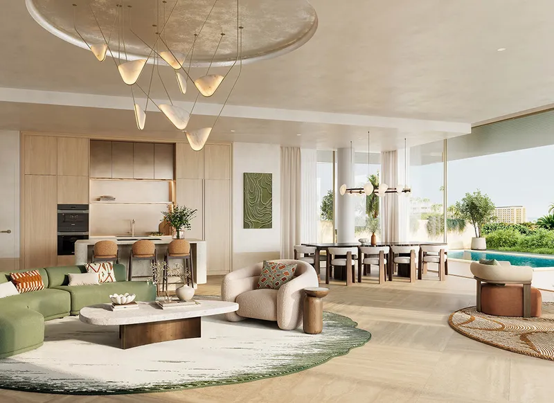 Living room of a Solaya garden residence in pale stone and timber, opening through full height glazing to the courtyard