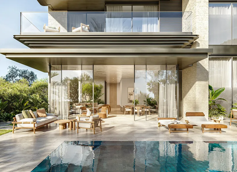 Shaded terrace of a ground floor garden residence at Solaya, opening onto a planted courtyard of more than three thousand square feet