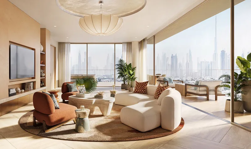 Living room at Solaya in warm stone and timber with a terrace beyond and the Downtown Dubai towers on the horizon