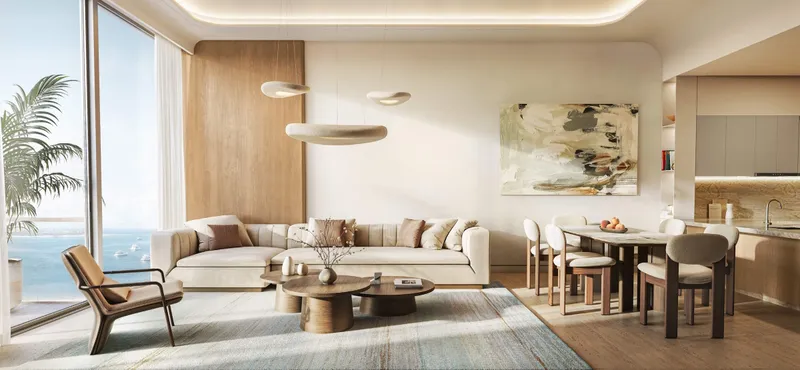 Living and dining area in an apartment at SOMA Residences with sea views through full-height glazing